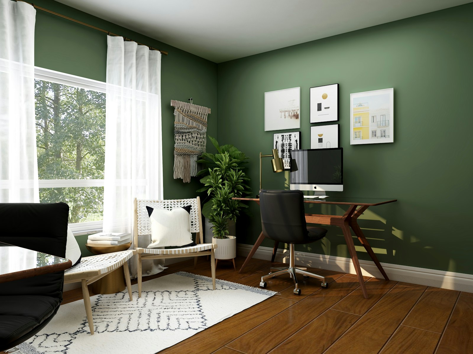 A home office with a wooden desk and deep green walls