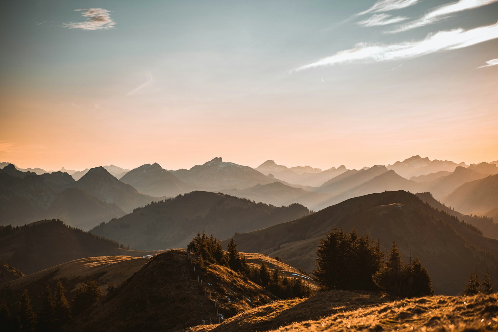 Layered mountain ridges under a warm evening sky