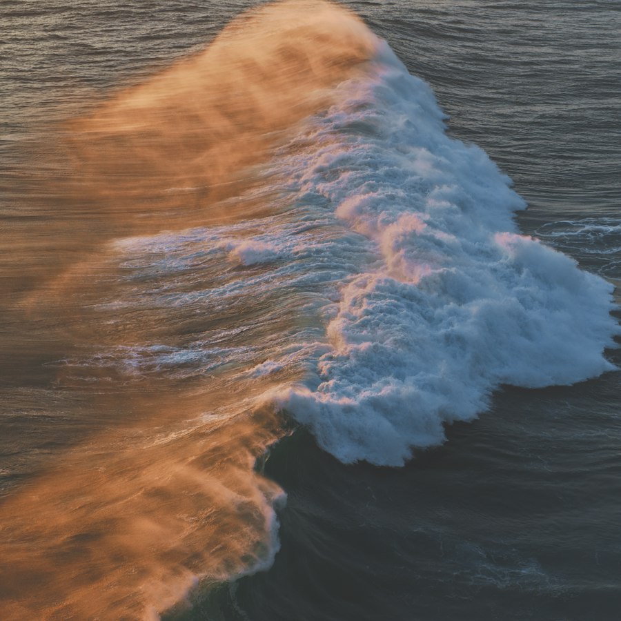 A wave breaking in amber light, seen from above